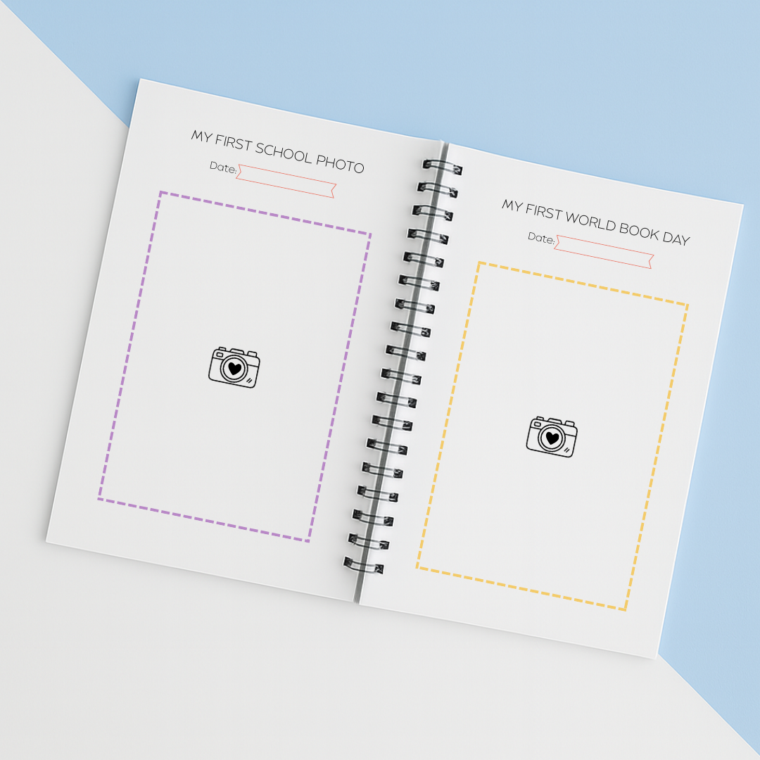 Open notebook with two photo frames for 'My First School Photo' and 'My First World Book Day' on a light blue background.